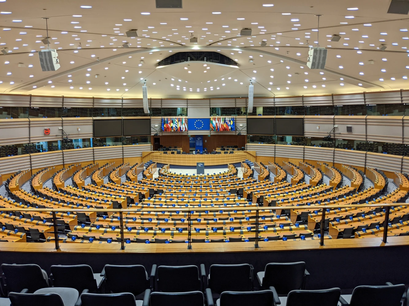 The empty semicircular plenary chamber of the European Parliament in Brussels, photographed in 2024.