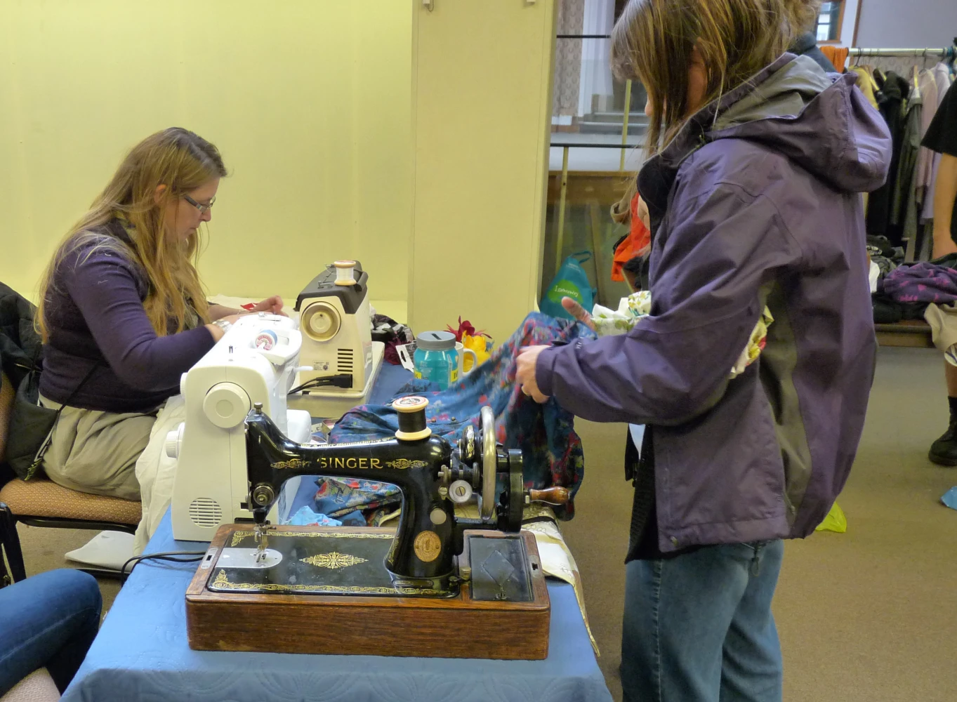People carrying out textile and sewing repairs at Reading Repair Cafe in England in October 2014.