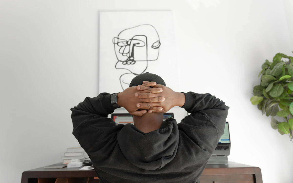 Freelancer leaning back at a desk while reviewing work on a computer