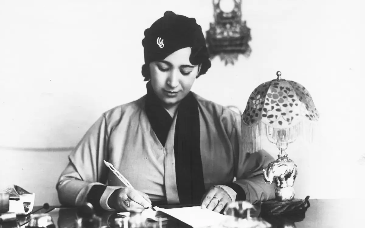 Black-and-white photograph of a writer working at a desk